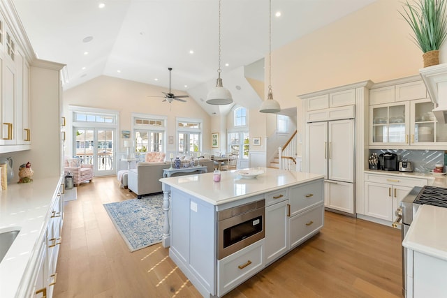 149 10th St, Avalon, NJ 08202 - kitchen featuring built in appliances, high vaulted ceiling, open floor plan, light countertops, and ceiling fan
