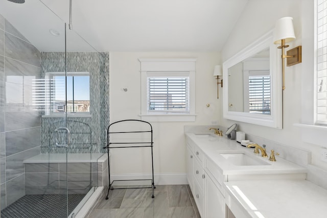149 10th St, Avalon, NJ 08202 - full bathroom with lofted ceiling, healthy amount of natural light, a shower stall, double vanity, and marble look tile flooring