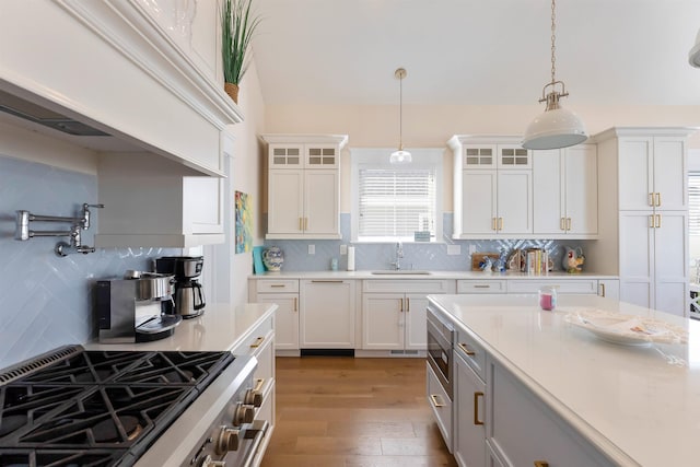 149 10th St, Avalon, NJ 08202 - kitchen with stainless steel appliances, light countertops, tasteful backsplash, and hanging light fixtures