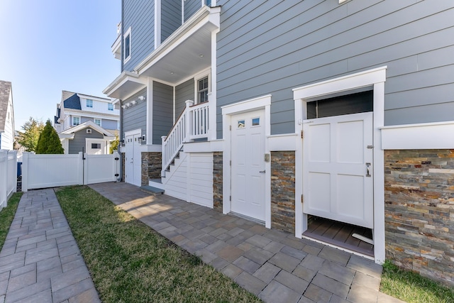 149 10th St, Avalon, NJ 08202 - entrance to property with a gate and stone siding
