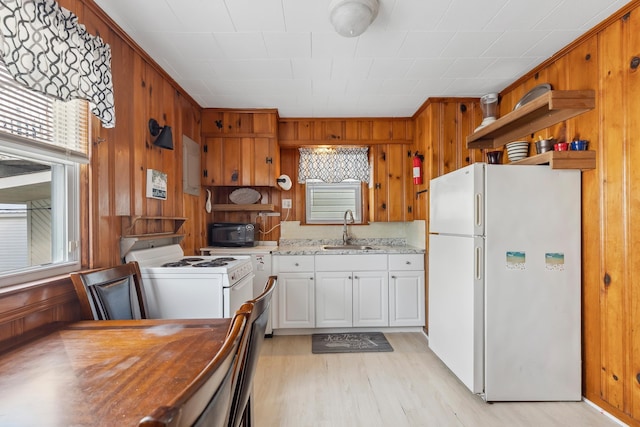 221 W 25th Ave, North Wildwood, NJ 08260 - kitchen featuring white appliances, light wood-style flooring, open shelves, wooden walls, and white cabinets