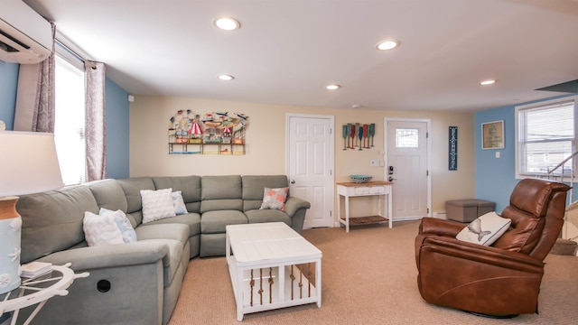 living area with a wall unit AC, recessed lighting, and light carpet
