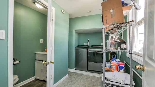 laundry room featuring washer and clothes dryer, laundry area, and baseboards