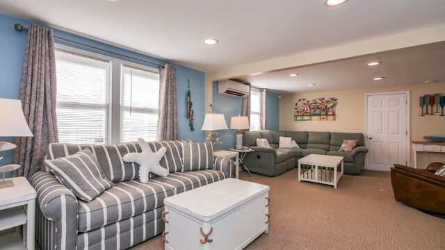 living room featuring an AC wall unit, recessed lighting, and light carpet