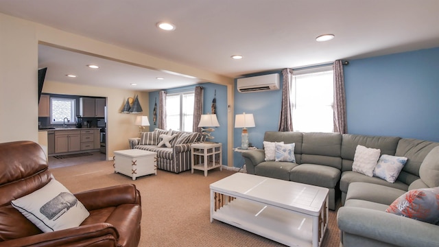 living area featuring a wall mounted air conditioner, light carpet, a wealth of natural light, and recessed lighting