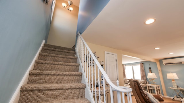 stairway with a wall unit AC, recessed lighting, and baseboards