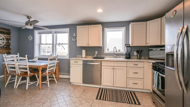 kitchen featuring a sink, appliances with stainless steel finishes, ceiling fan, and a healthy amount of sunlight