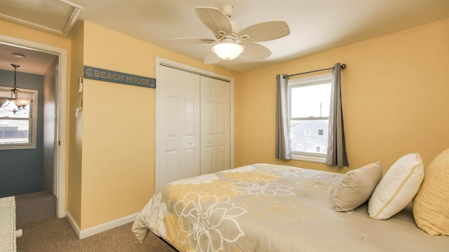carpeted bedroom featuring a closet, baseboards, and a ceiling fan