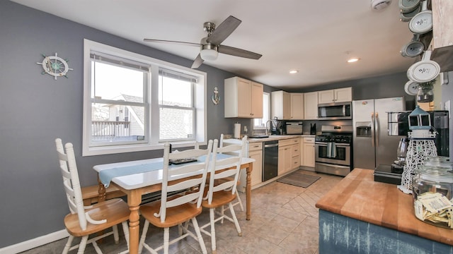kitchen featuring baseboards, light tile patterned flooring, recessed lighting, ceiling fan, and appliances with stainless steel finishes