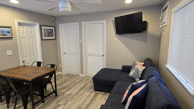 living room featuring ceiling fan and light wood-type flooring