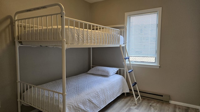 bedroom featuring a baseboard radiator and wood-type flooring