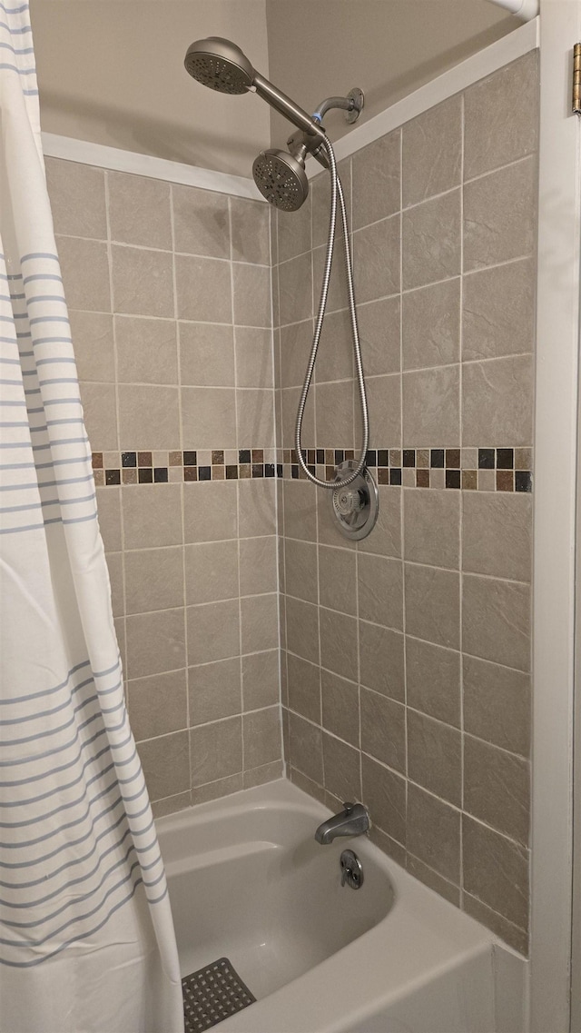 bathroom featuring shower / bathtub combination with curtain