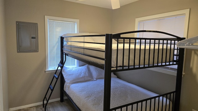 bedroom with hardwood / wood-style flooring and electric panel