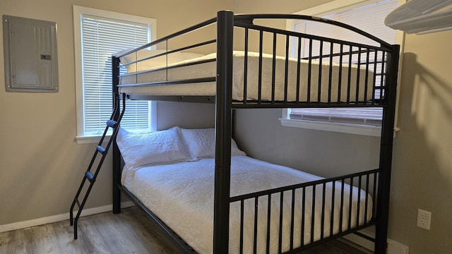 bedroom with hardwood / wood-style flooring and electric panel