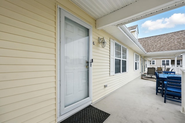 3102 Ocean Ave Unit G, Wildwood, NJ 08260 - doorway to property with outdoor dining area, a shingled roof, and a patio