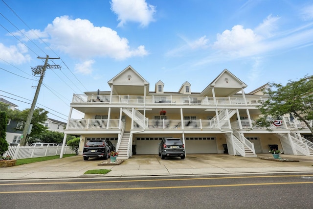 3102 Ocean Ave Unit G, Wildwood, NJ 08260 - view of front of house featuring stairs, covered porch, a garage, and concrete driveway