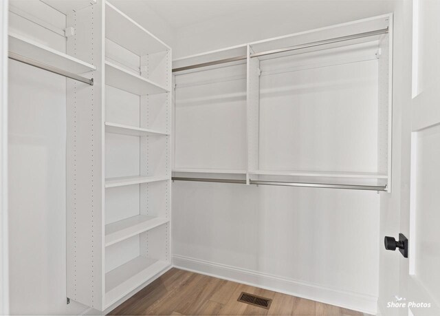 spacious closet with wood finished floors and visible vents