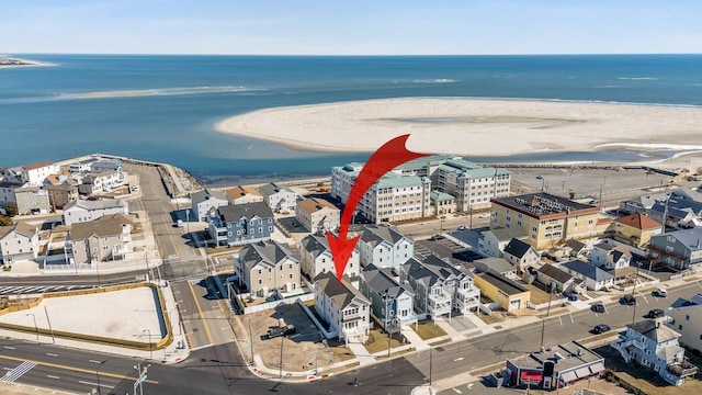 aerial view with a water view and a view of the beach