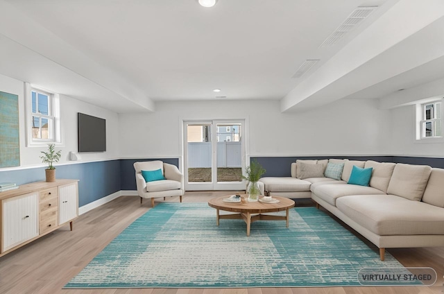 living room with light wood-style floors, baseboards, a wealth of natural light, and recessed lighting