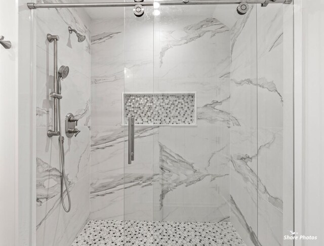 full bathroom with a marble finish shower