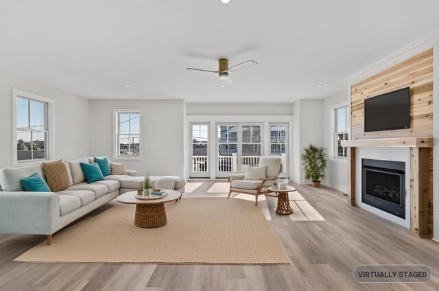 living room with a fireplace, recessed lighting, a ceiling fan, wood finished floors, and baseboards