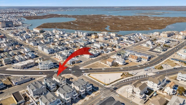 birds eye view of property with a water view and a residential view