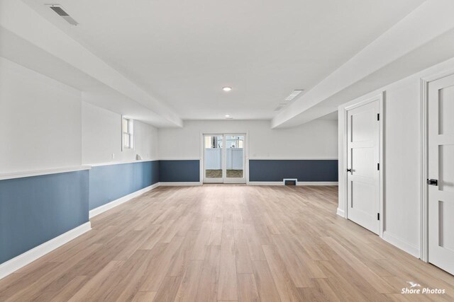 empty room with light wood-type flooring, visible vents, baseboards, and recessed lighting