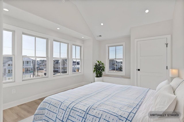 bedroom with visible vents, baseboards, lofted ceiling, wood finished floors, and recessed lighting