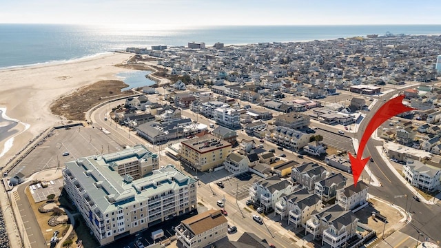 birds eye view of property with a beach view and a water view