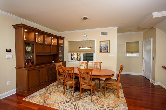 dining area with dark hardwood / wood-style floors and ornamental molding