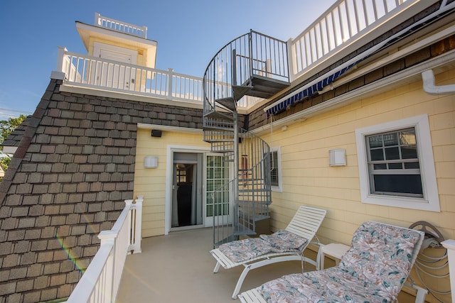 view of patio featuring a balcony