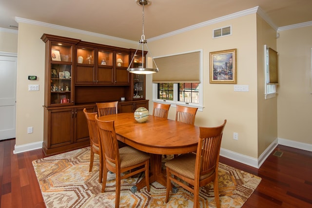 dining area featuring dark hardwood / wood-style flooring and crown molding