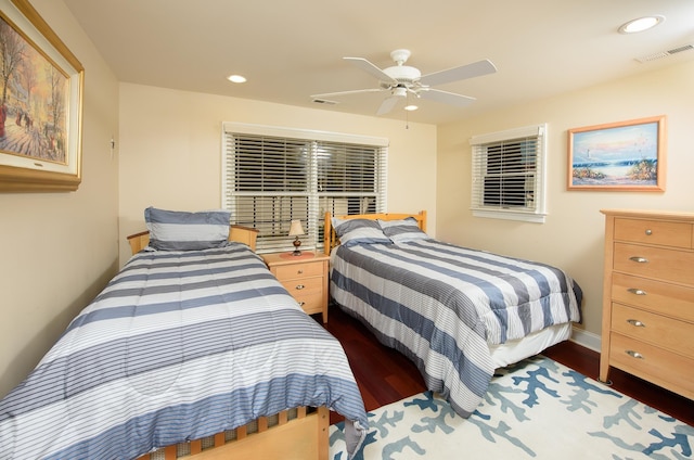 bedroom with ceiling fan and dark hardwood / wood-style floors