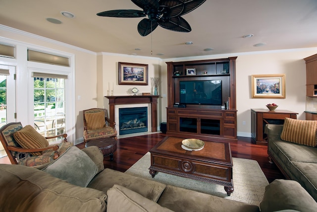 living room with dark hardwood / wood-style flooring, ceiling fan, and ornamental molding