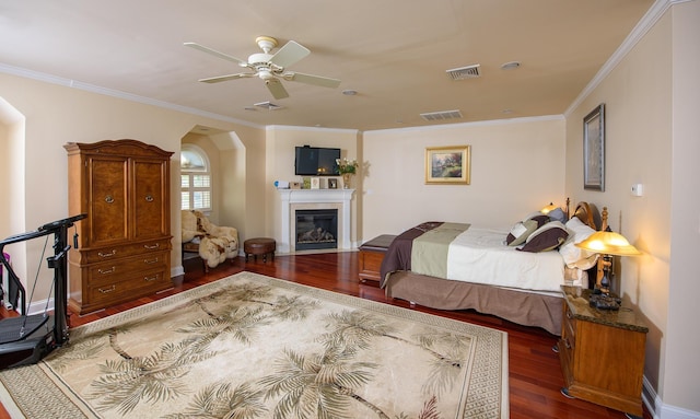 bedroom featuring ceiling fan, dark wood-type flooring, and ornamental molding