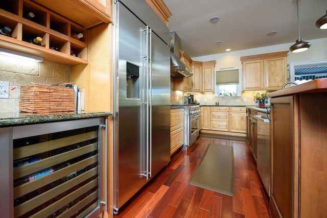 kitchen with decorative backsplash, premium appliances, beverage cooler, light brown cabinets, and decorative light fixtures