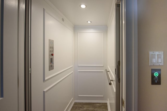 details featuring hardwood / wood-style floors, elevator, and crown molding