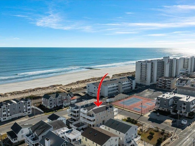 birds eye view of property featuring a water view and a beach view