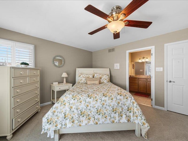 carpeted bedroom featuring ensuite bathroom and ceiling fan