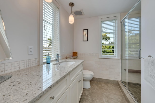 312 S Lake Dr, Cape May Point, NJ 08212 - full bathroom with vanity, tile walls, a stall shower, tile patterned floors, and a wainscoted wall