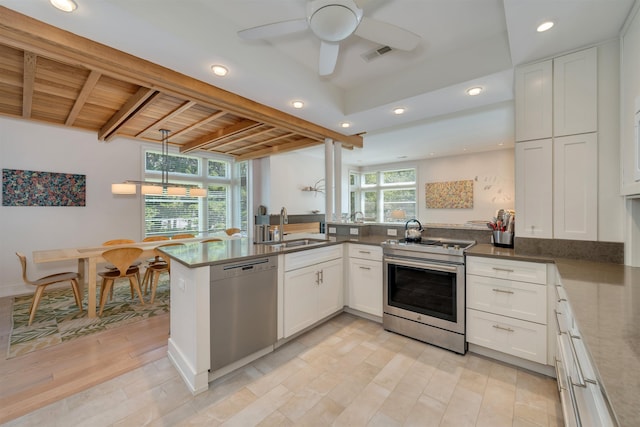 312 S Lake Dr, Cape May Point, NJ 08212 - kitchen featuring stainless steel appliances, white cabinets, light wood-style flooring, recessed lighting, and a peninsula