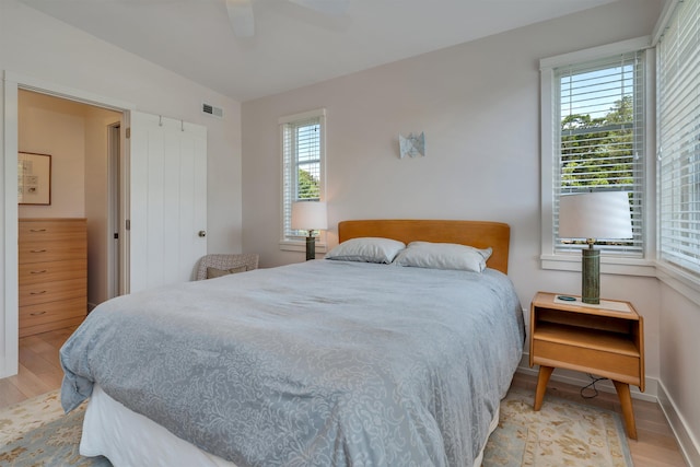 312 S Lake Dr, Cape May Point, NJ 08212 - bedroom featuring light wood finished floors, multiple windows, and a ceiling fan