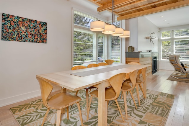 312 S Lake Dr, Cape May Point, NJ 08212 - dining area with light wood finished floors, a wooden ceiling with exposed beams, and a fireplace