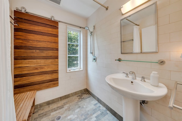 312 S Lake Dr, Cape May Point, NJ 08212 - full bathroom featuring a tile shower and tile walls