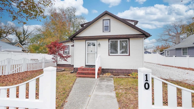 bungalow-style home featuring a front yard