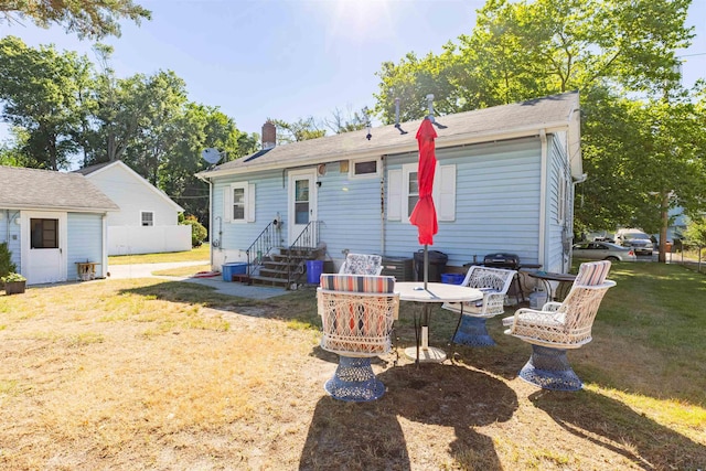 rear view of property with a yard