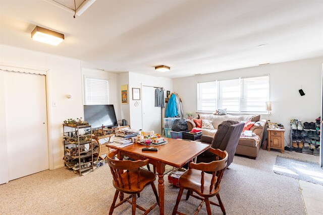 dining space with light colored carpet