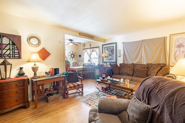 living room featuring light wood-type flooring and ceiling fan