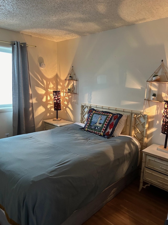 bedroom featuring wood-type flooring and a textured ceiling