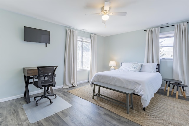 bedroom featuring a ceiling fan, wood finished floors, and baseboards